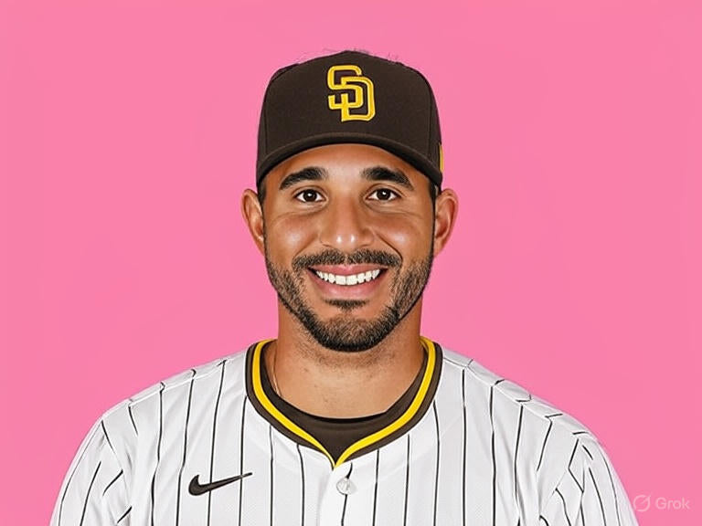 San Diego Padres outfielder Fernando Tatis Jr. holding Rawlings Platinum Glove trophy on the field